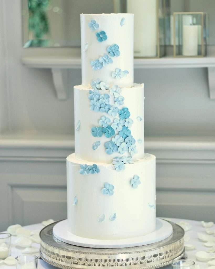 White buttercream cake with blue piped blossoms at The Orangery, Maidstone
