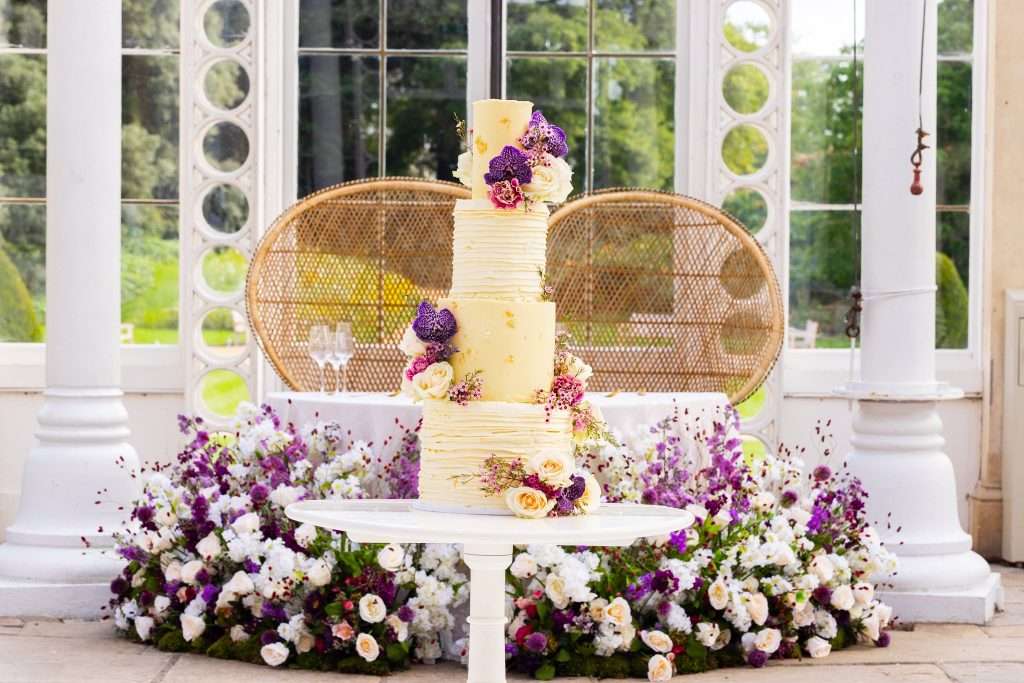 wedding cake with purple flowers