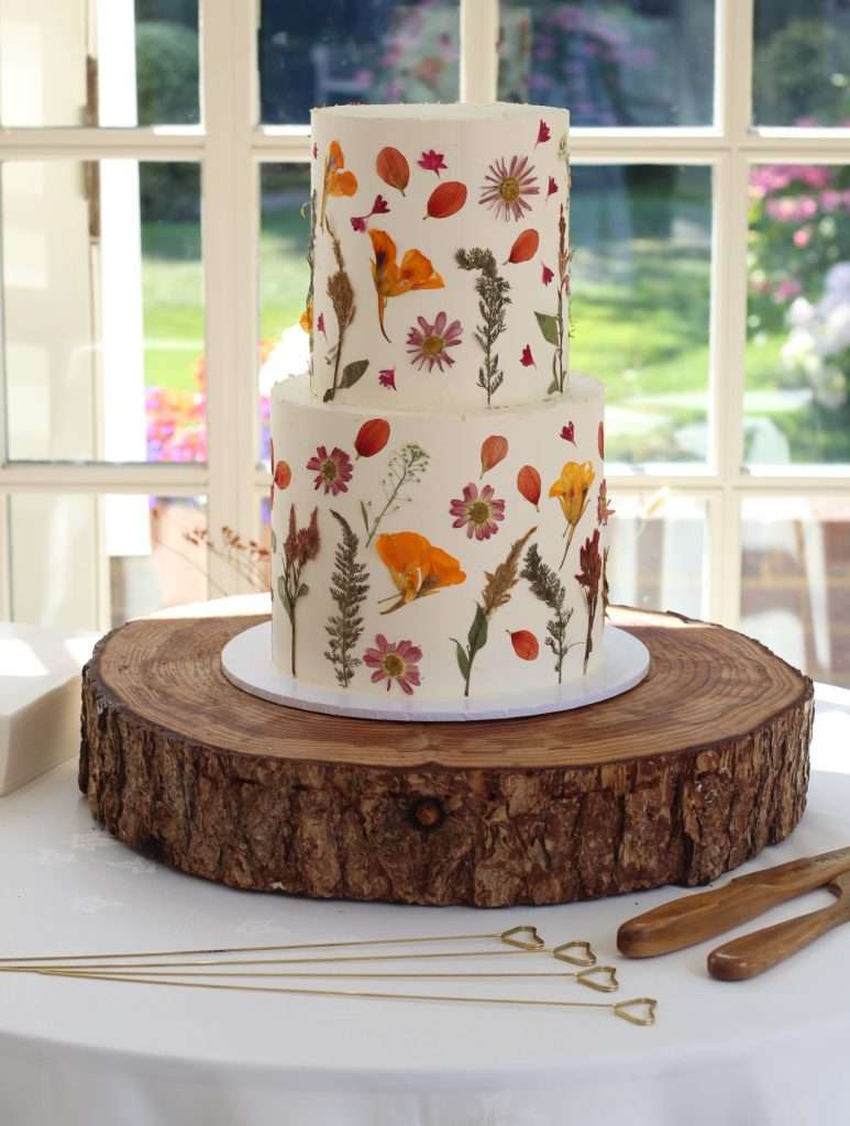 Two tier pressed flower cake in autumnal colours at Oaks Farm